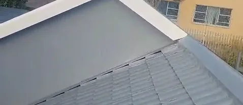 Freshly painted grey roof tiles below a painted gable